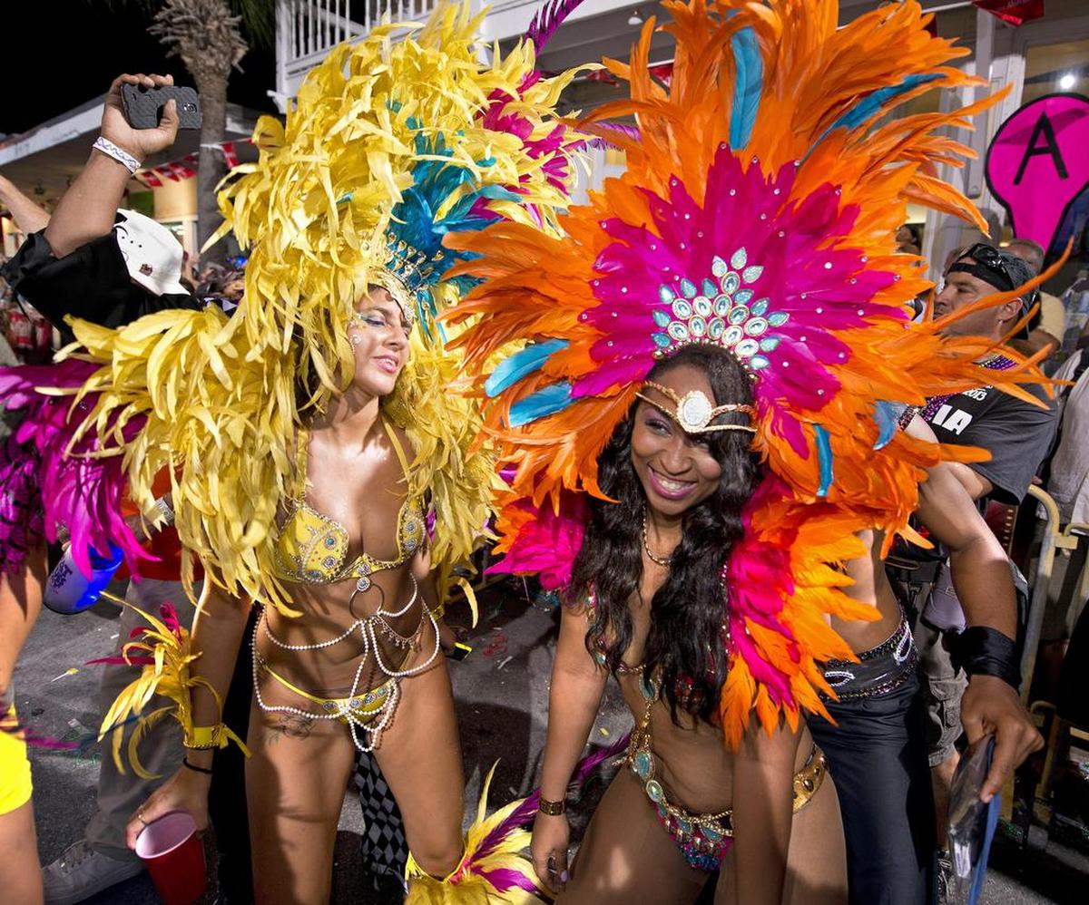 Feathered dancers prance down Duval Street in Key West during a previous Fantasy Fest parade. The annual festival originated in 1979 and has matured into the Florida Keys largest special event.