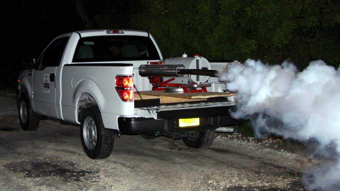 A Florida Keys Mosquito Control District truck sprays pesticide into a wooded area on Stock Island in a joint effort with the U.S. Navy to combat the Asian tiger mosquito. (Mosquito Control photo)