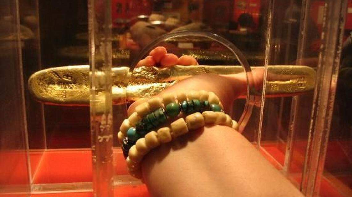 The gold bar was held in a case designed to let people touch it but not remove it.