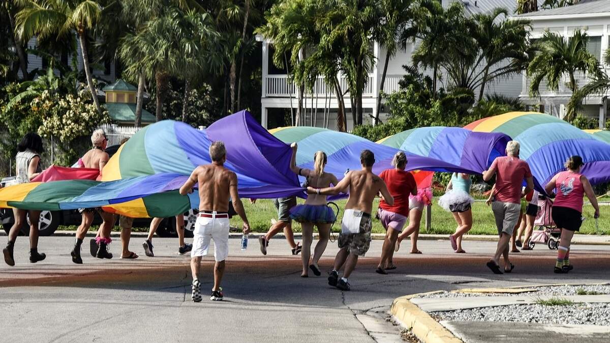 Participants in a previous Pride parade carry the sea-to-sea rainbow flag.