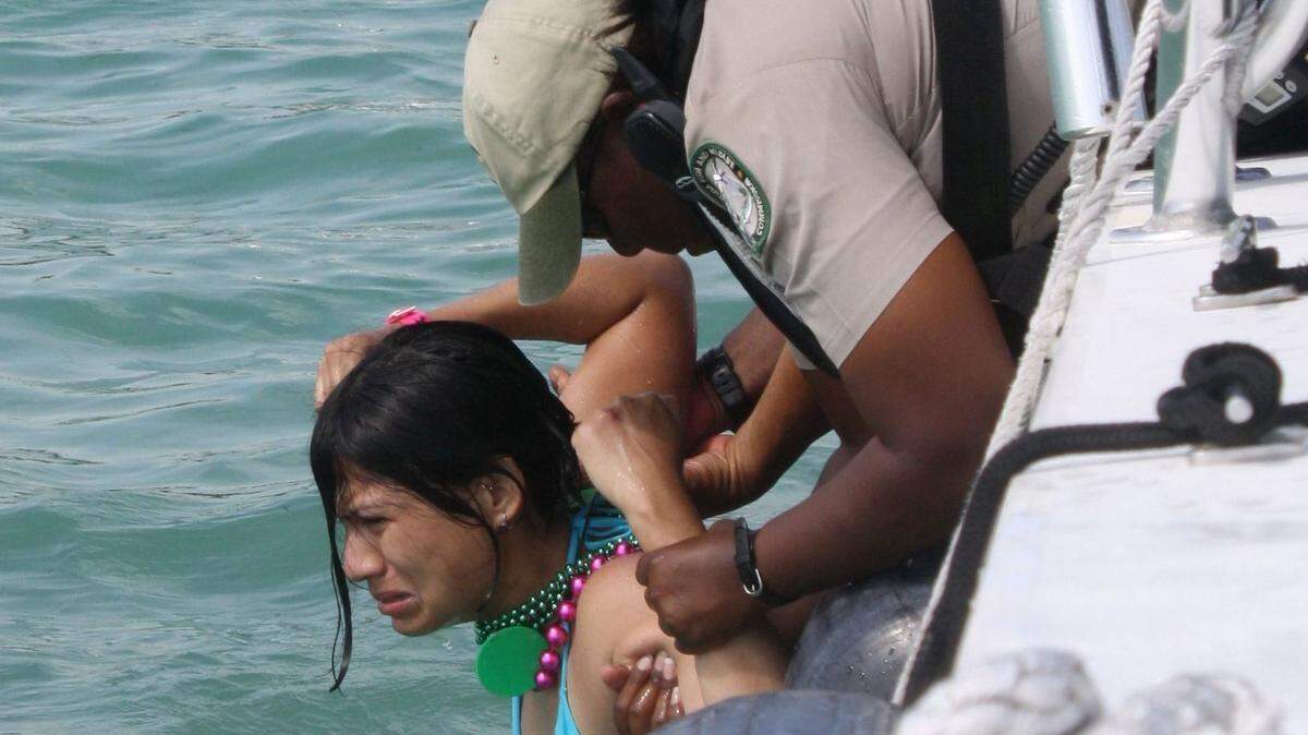 Florida Fish and Wildlife Conservation Commission officers subdue an intoxicated young woman at the sandbar off Whale Harbor in 2010. Parties at the sandbar have traditionally kept law enforcement busy. The area remains a problem for the FWC and Sheriffs Office, said Sheriff Rick Ramsay.
