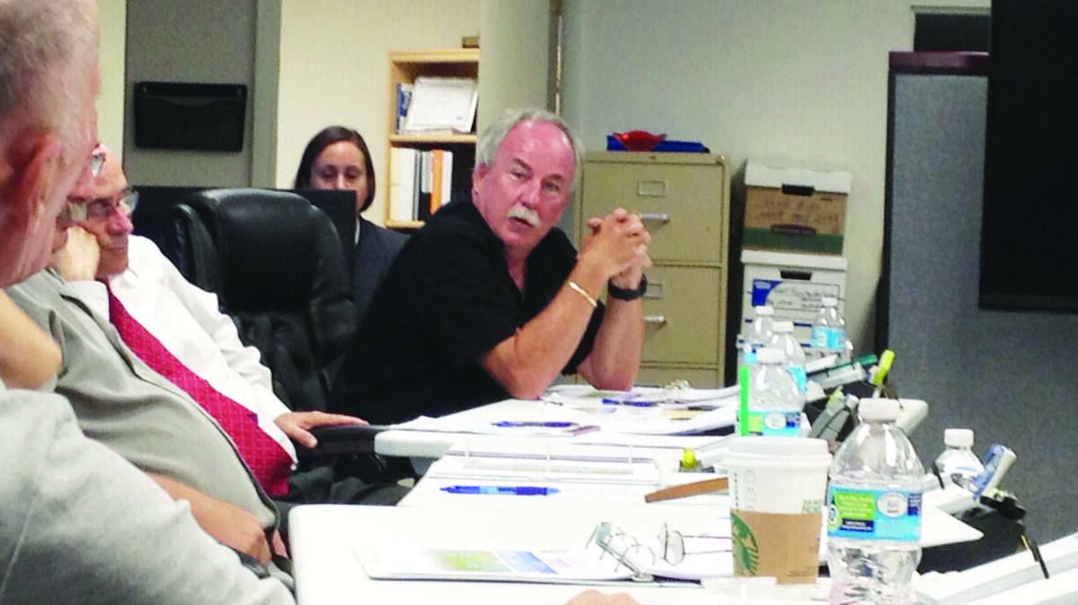 Key Largo Wastewater Treatment District commissioners Steve Gibbs, shown from the back, and Robby Majeska, facing the camera, argue over the potential reprimand of the district's general manager Paul Christian.