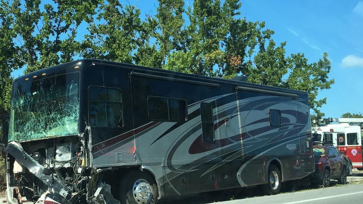 A motor home has damage to its front end and windshield, and a red car appears to have hit it from behind. Three people died in the crash, which also involved a septic tank pump truck, Monday, March 5.