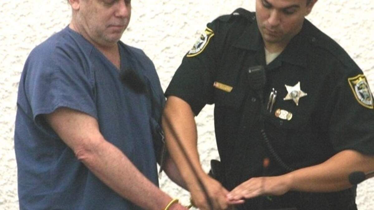 A Monroe County Sheriff's Office deputy processes William Skinner following his May 2011 convictions.
