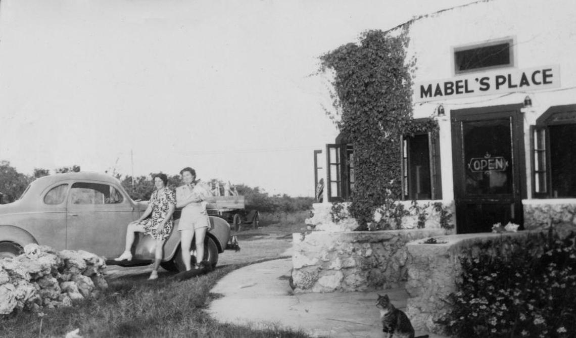 Two women wait outside of Mabel’s Place, which used to be on County Road 905.