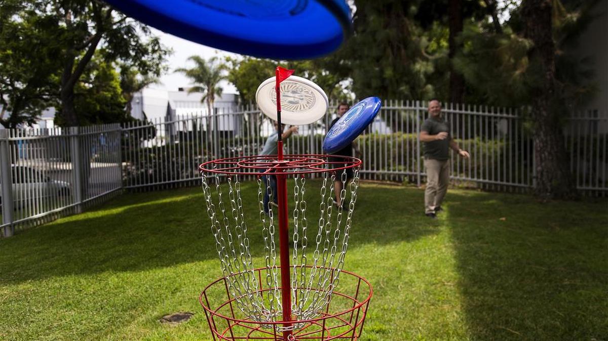 Employees at Wham-O play with new ultimate frisbees at the company's headquarters on Aug. 2 in Carson, Calif.