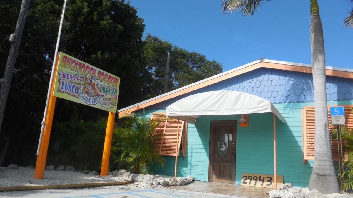 The Bucktooth Rooster is at mile marker 29.9 bayside, next to Coldwell Banker Schmitt Real Estate.