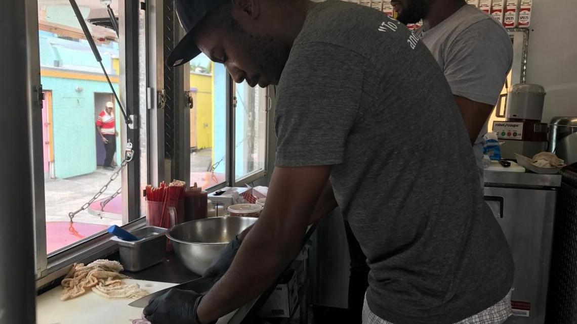Cook Arzhiel Pierre slices onions while executive Chef Camellien Octela, Jr. preps for lunch inside a food truck that has been substituting for Snappers Oceanfront Restaurant and Bar’s kitchen in the wake of Hurricane Irma.