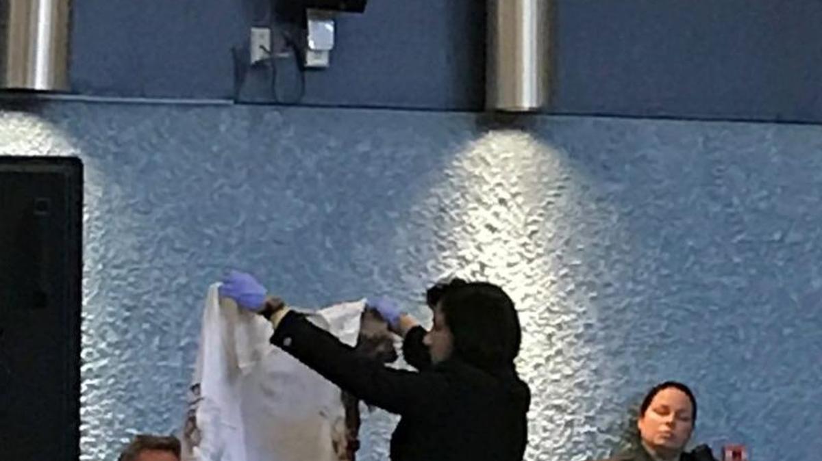 Assistant State Attorney Colleen Dunne holds a blood stained shirt belonging to one of the three men Derek David shot in Key West on March 21, 2016.
