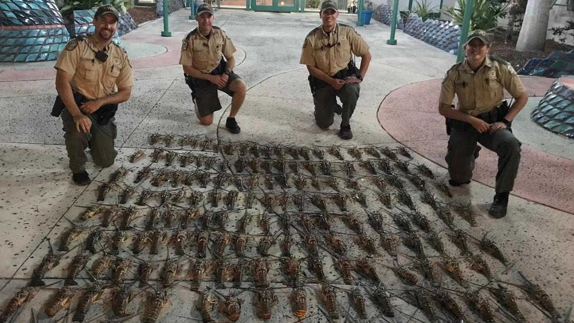 The arresting officers show what they seized from the boat.