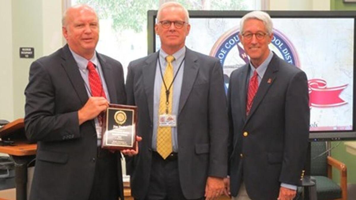 Jim Drake, the finance director of the Monroe County School District, Superintendent Mark Porter and School Board Vice Chairman Andy Griffiths gather at the Oct. 25 board meeting. Drake deserves credit for the latest state audit of the district that found no significant problems, Porter says.