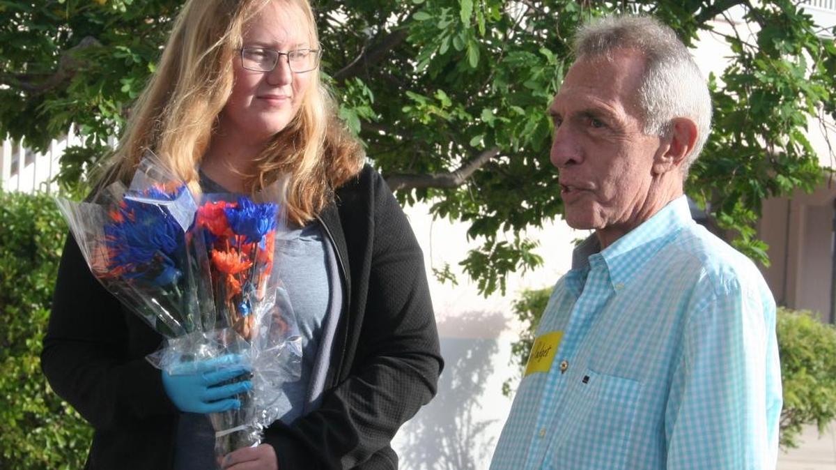 Anna Mott is congratulated by John Padget at Key West High School on Tuesday.