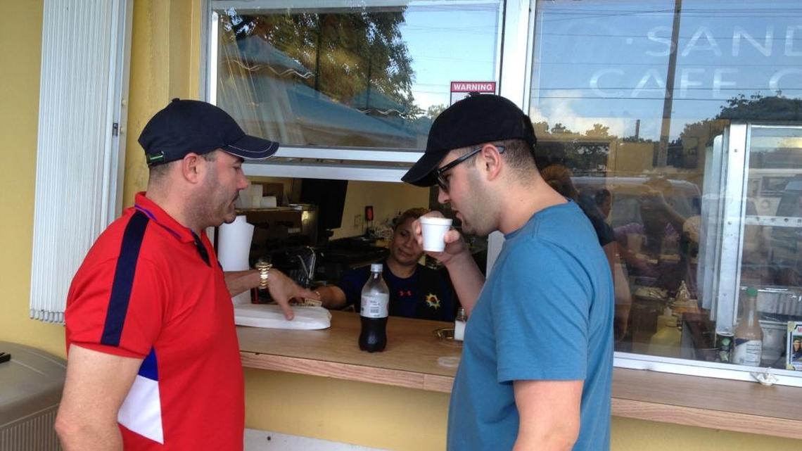 Carlos and Daniel Subaroo order coffee at the Sunrise Latin Cafe in Tavernier Friday. Daniel Subaroo said President Obama’s decision to end wet-foot, dry-foot ‘sucks for the people who are left there.’
