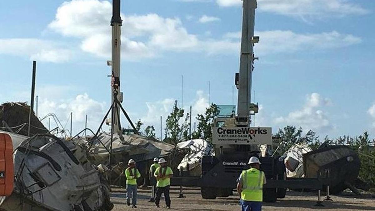 Cranes remove sunken boats and some that were dropped in mangroves at the Boot Key Harbor City Marina Oct. 17, 2017, in Marathon.