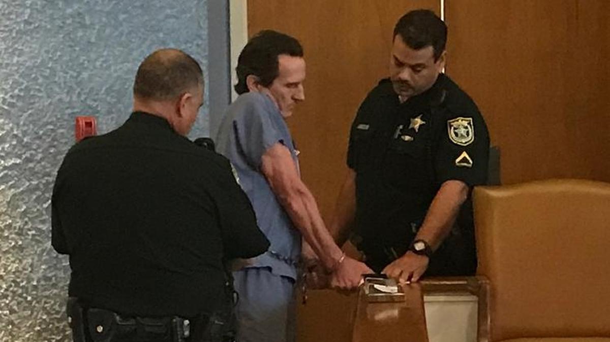Monroe County Sheriff’s Office deputies take fingerprints from a shackled Robert Schminky on Tuesday, March 20, 2018, after Circuit Judge Luis Garcia sentenced him to two life terms for his 2015 shootout with deputies and a Florida Highway Patrol trooper.