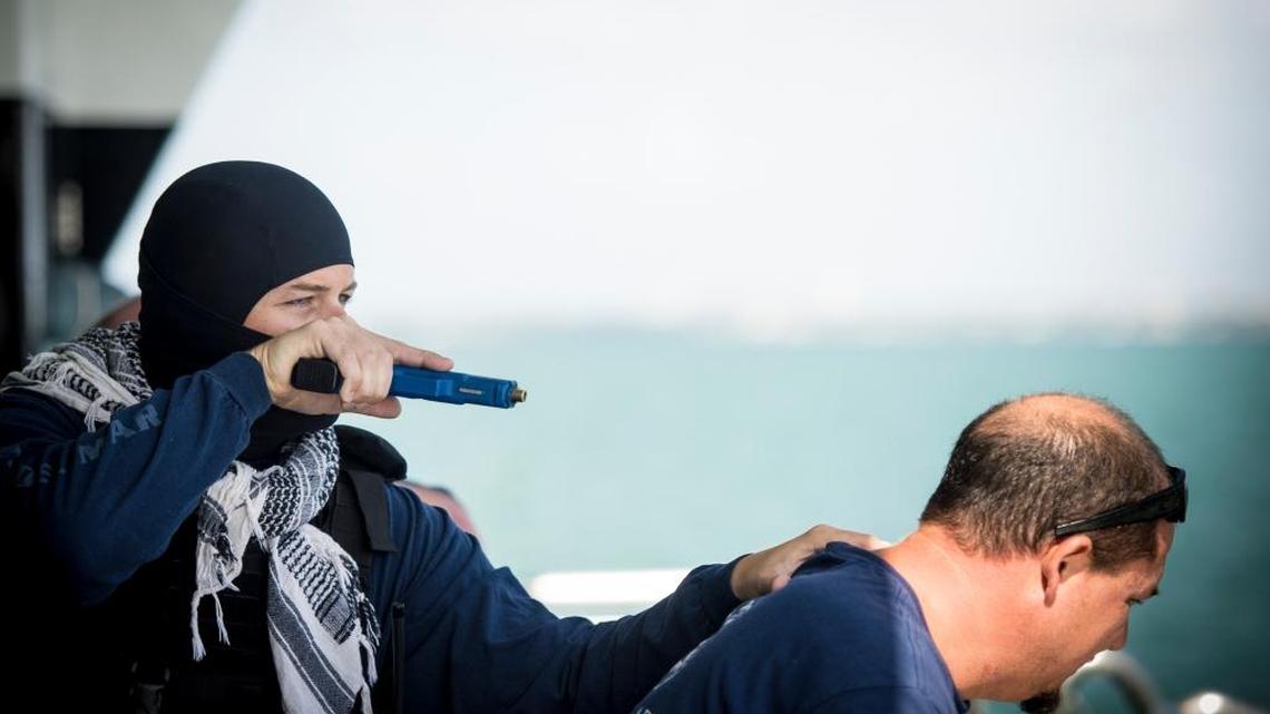A U.S. Customs and Border Protection agent plays a terrorist and holds a ship crewman hostage during an anti-terrorism exercise held on a small cruise ship on Biscayne Bay July 6.