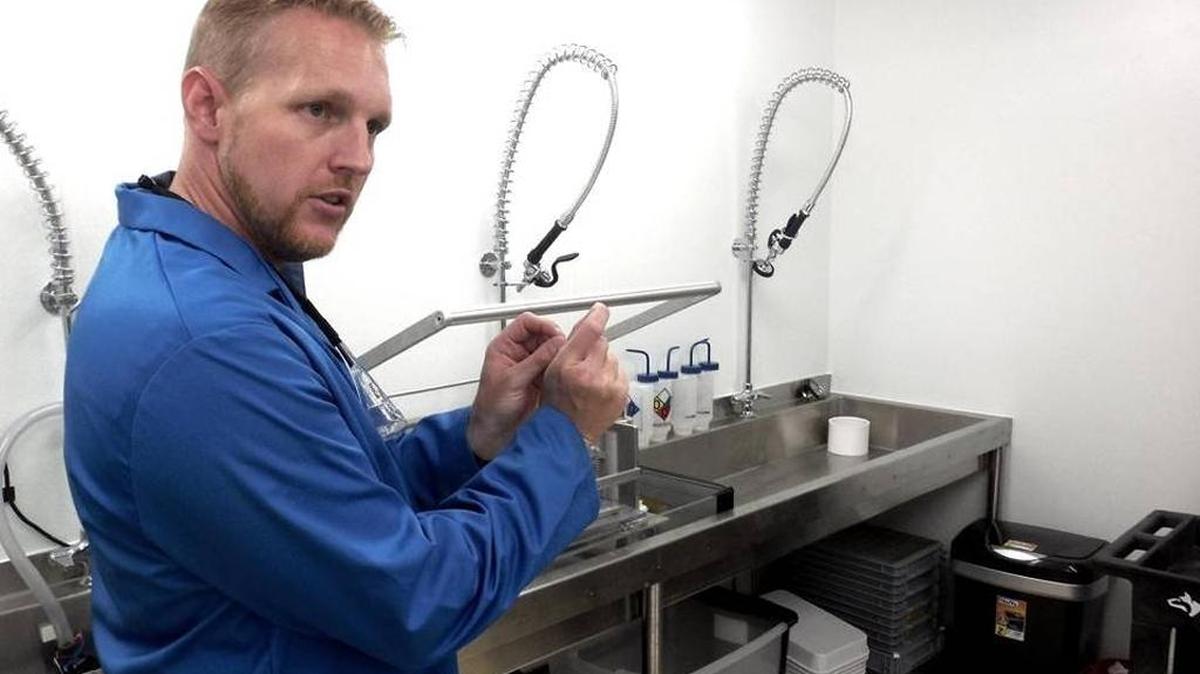 Derric Nimmo, product development manager for British insect-control firm Oxitec, explains the process to alter the genes of Aedes aegypt mosquitoes in Oxitec’s lab at the Florida Keys Mosquito Control District’s Marathon location.