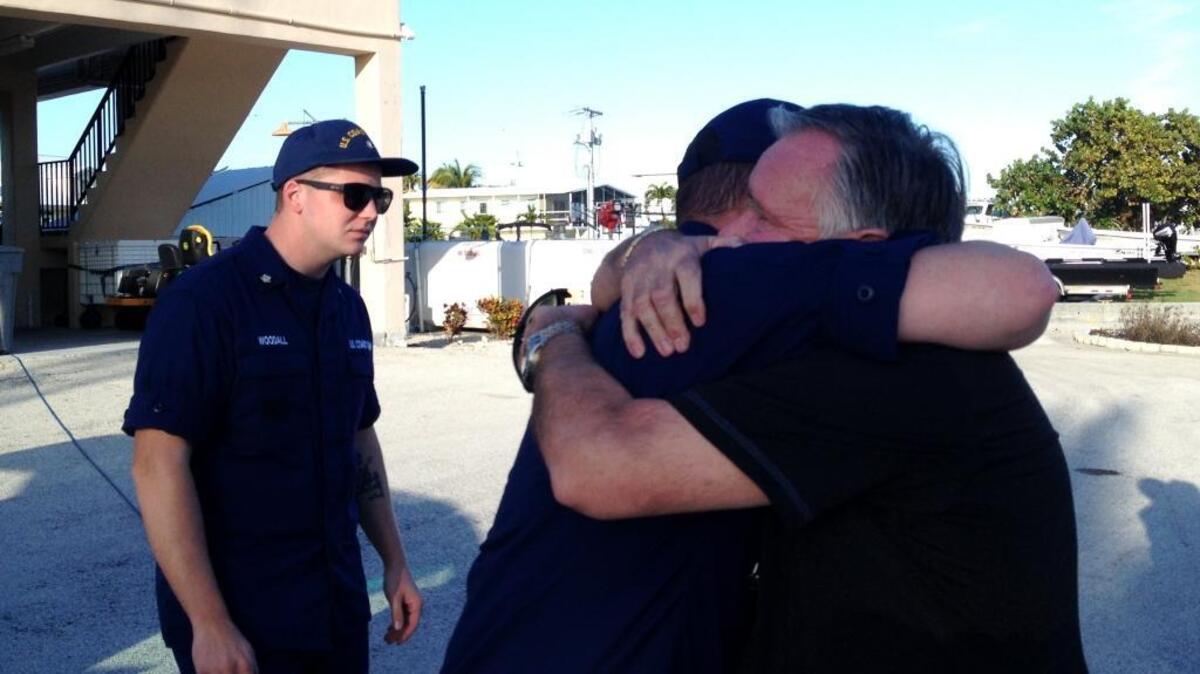 Brian Stewart (right), father of Rob, is embraced upon hearing that the search is suspended.