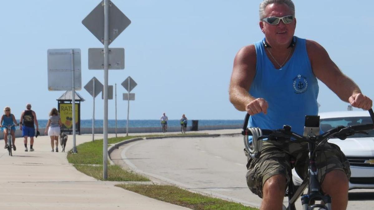 A bicyclist Thursday cruises down South Roosevelt Boulevard using the oceanside sidewalk.