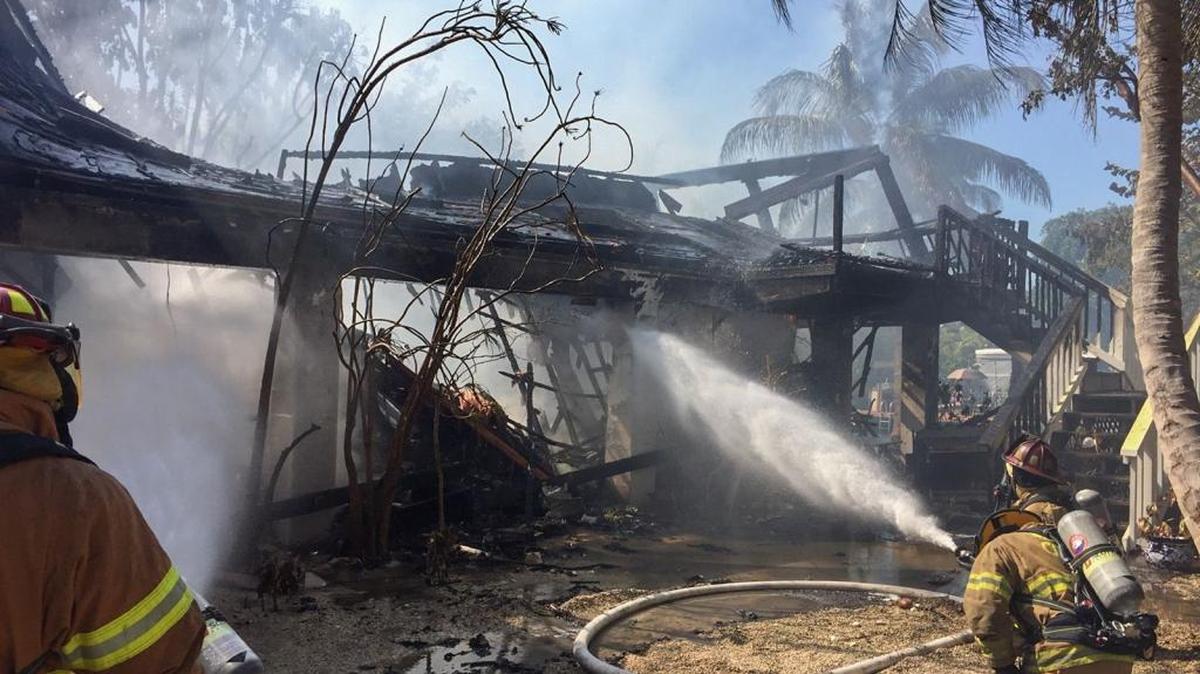 Monroe County Fire Rescue Firefighter Michael Summers and Lt. Dany Ribot train their hoses on a Bay Point house as it burns to the ground Thursday morning, Jan. 26.