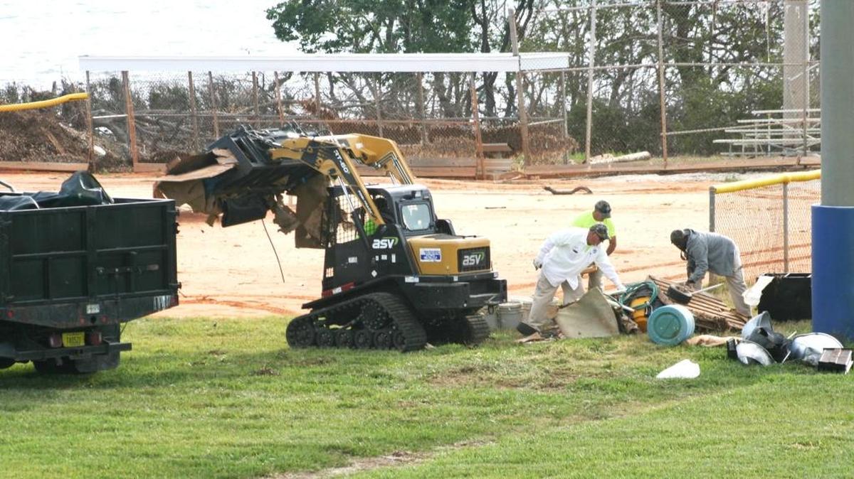 Monroe County Public Works staffers on Thursday remove debris from athletic fields at Harry Harris Park in Tavernier, closed since Hurricane Irma in September. Areas of the park are expected to open around Feb. 10, but the ball fields and the Wilkinson Point area will remain closed for a time. No electricity has been restorned to the park yet.