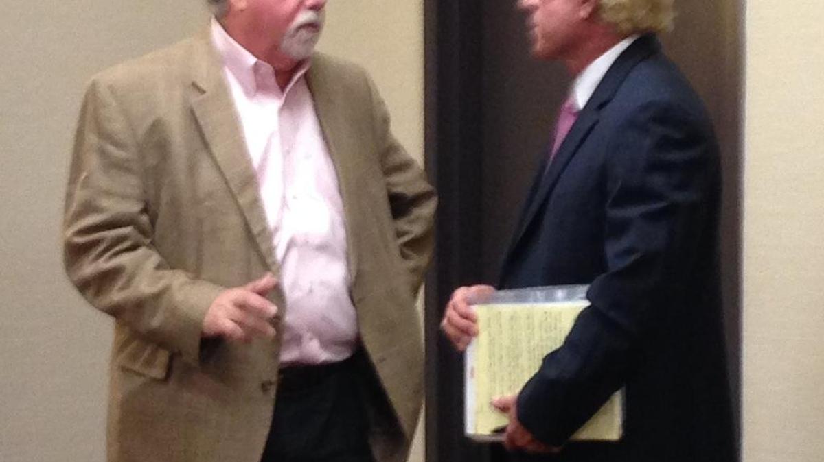 State Medical Examiners Commission chairman Stephen Nelson (left) speaks with county medical examiner Thomas Beaver after a Wednesday vote to deny a recommendation for Beaver’s reappointment.
