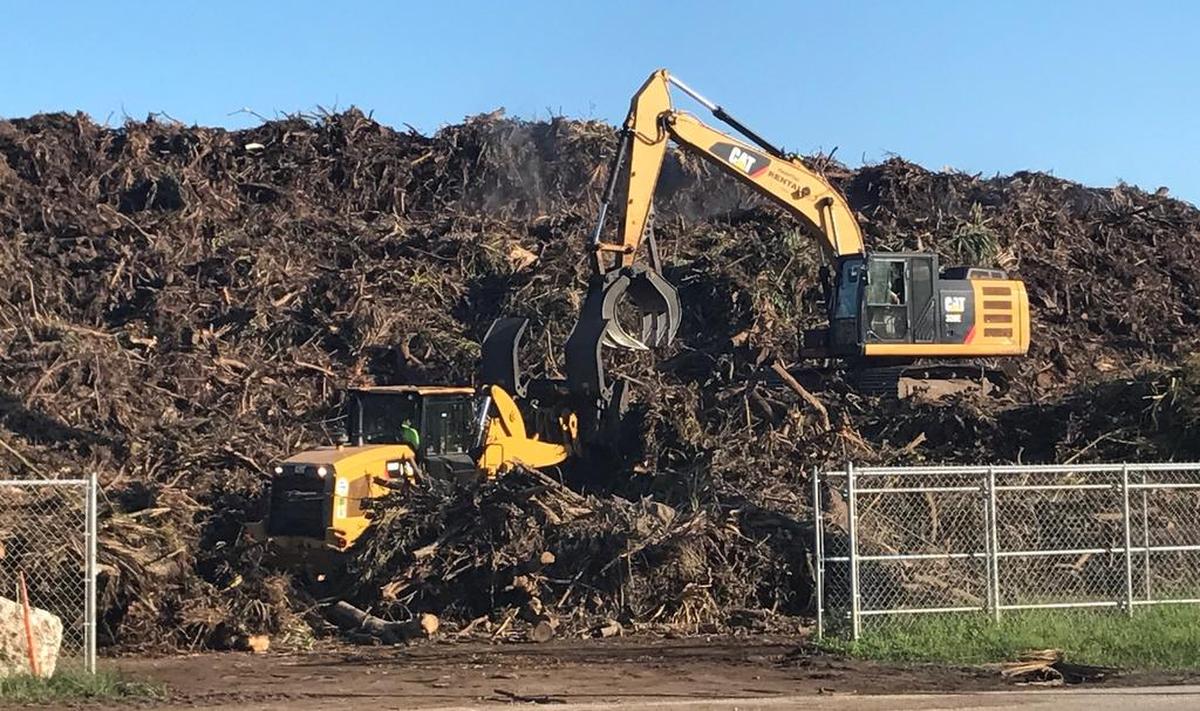 A crane adds to an ever-growing pile of vegetative debris from Hurricane Irma at a Key Largo site, one of several throughout the Florida Keys in the aftermath of Hurricane Irma, which struck the Keys on Sept. 10, 2017.