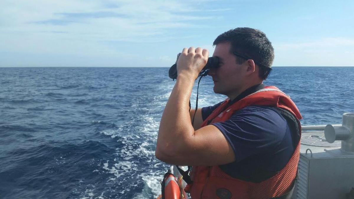 A U.S. Coast Guard crewman searches the water off Islamorada Wednesday for any signs of documentary filmmaker and conservationist Rob Stewart, who went missing diving the deep-water wreck of the Queen of Nassau Tuesday.