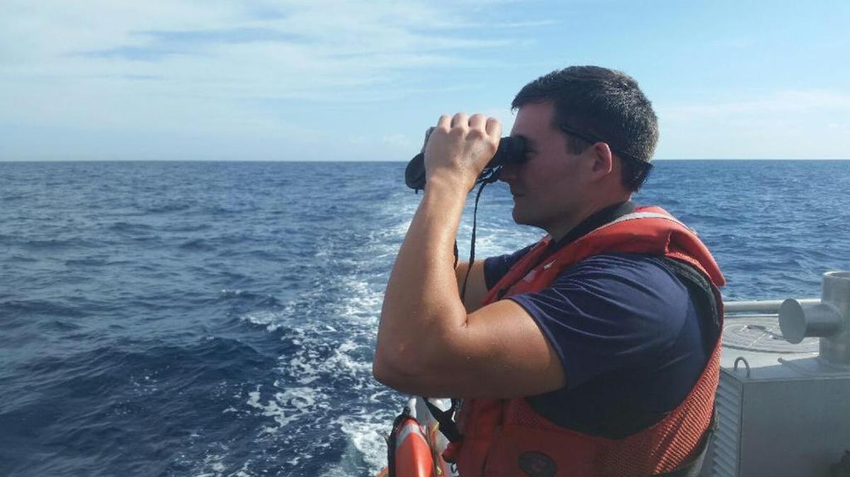 A U.S. Coast Guard crewman searches the water off Islamorada for any signs of documentary filmmaker and conservationist Rob Stewart, who went missing diving the deep-water wreck of the Queen of Nassau Tuesday.