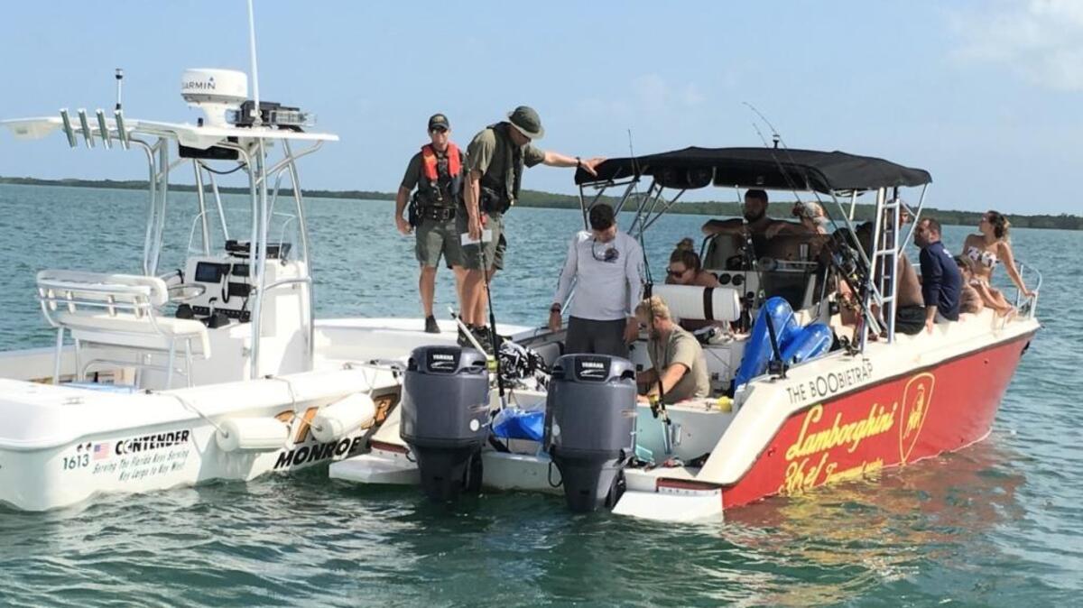 Monroe County Sheriff’s Office deputies check a boat for possible resource violations Wednesday off Marathon during the mini-season.