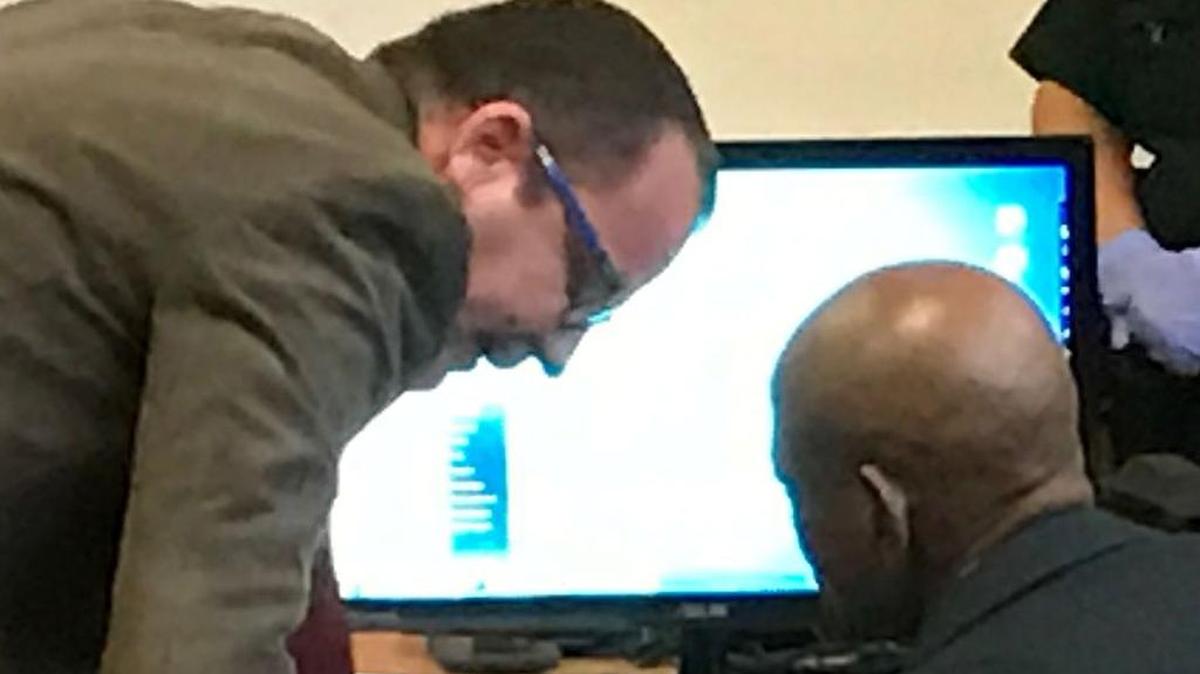 Public defender Jerome Gilhooley speaks with his client, John Lee Hayes after a jury found him guilty of rape, aggravated assault, kidnapping and theft.