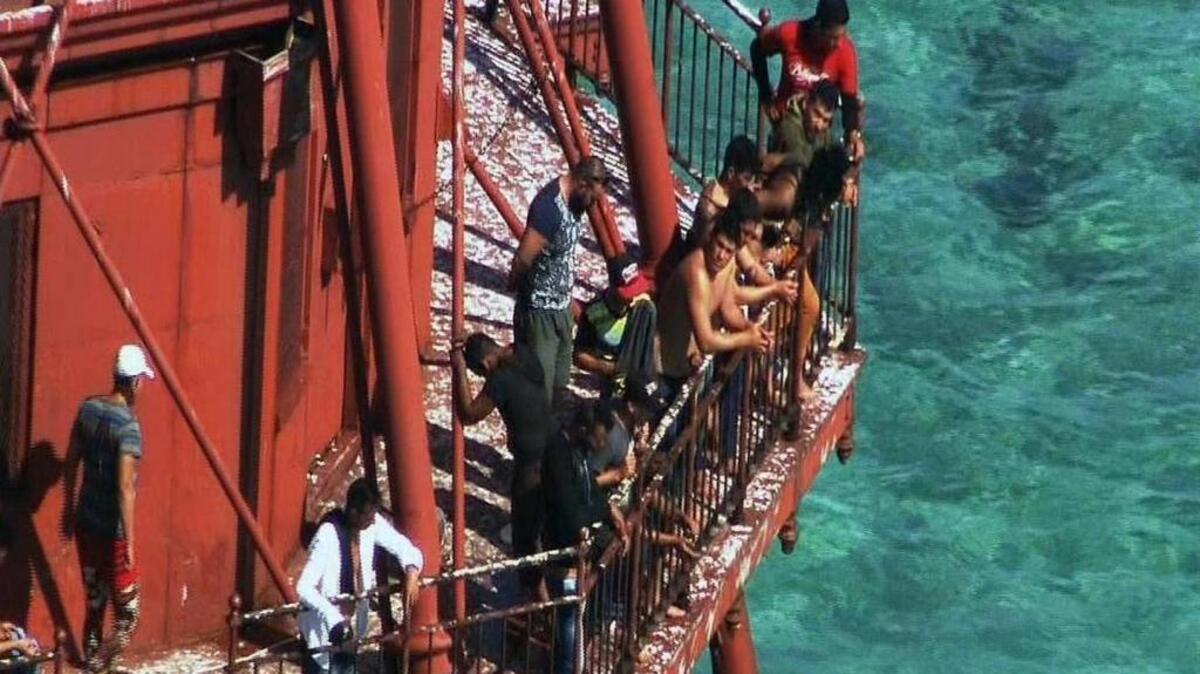 A group of Cubans stood atop American Shoal Lighthouse off Sugarloaf Key in standoff with Coast Guard on Friday, May 20, 2016.
