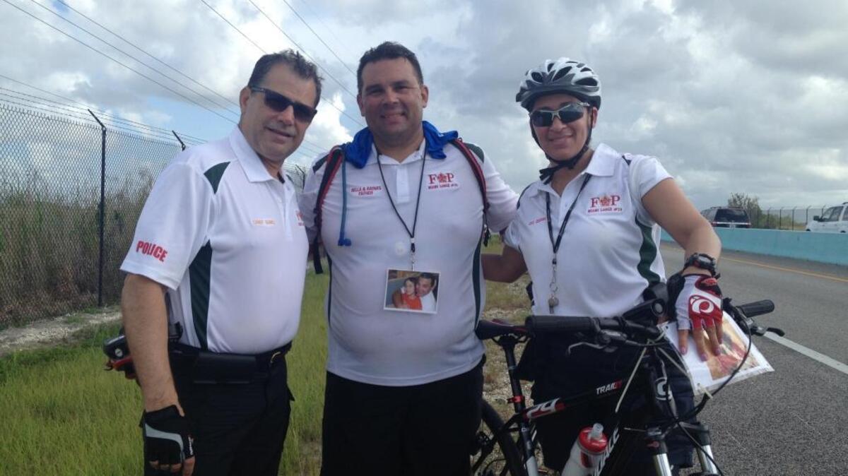 City of Miami Assistant Police Chief Jorge Gomez, Live Like Bella Childhood Cancer Foundation’s Raymond Rodriguez-Torres and Miami Police Officer Yelitza Cedano stop for a photo on the 18 Mile Stretch of U.S. 1 on their way down to Key West Wednesday, July 13.