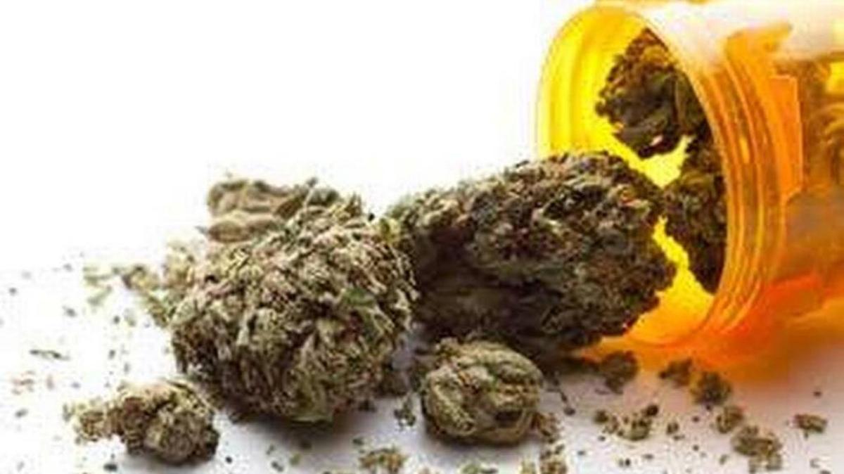 State officials are waiting to see how Florida’s law allowing medical marijuana squares with federal law prohibiting pot users from owning firearms.