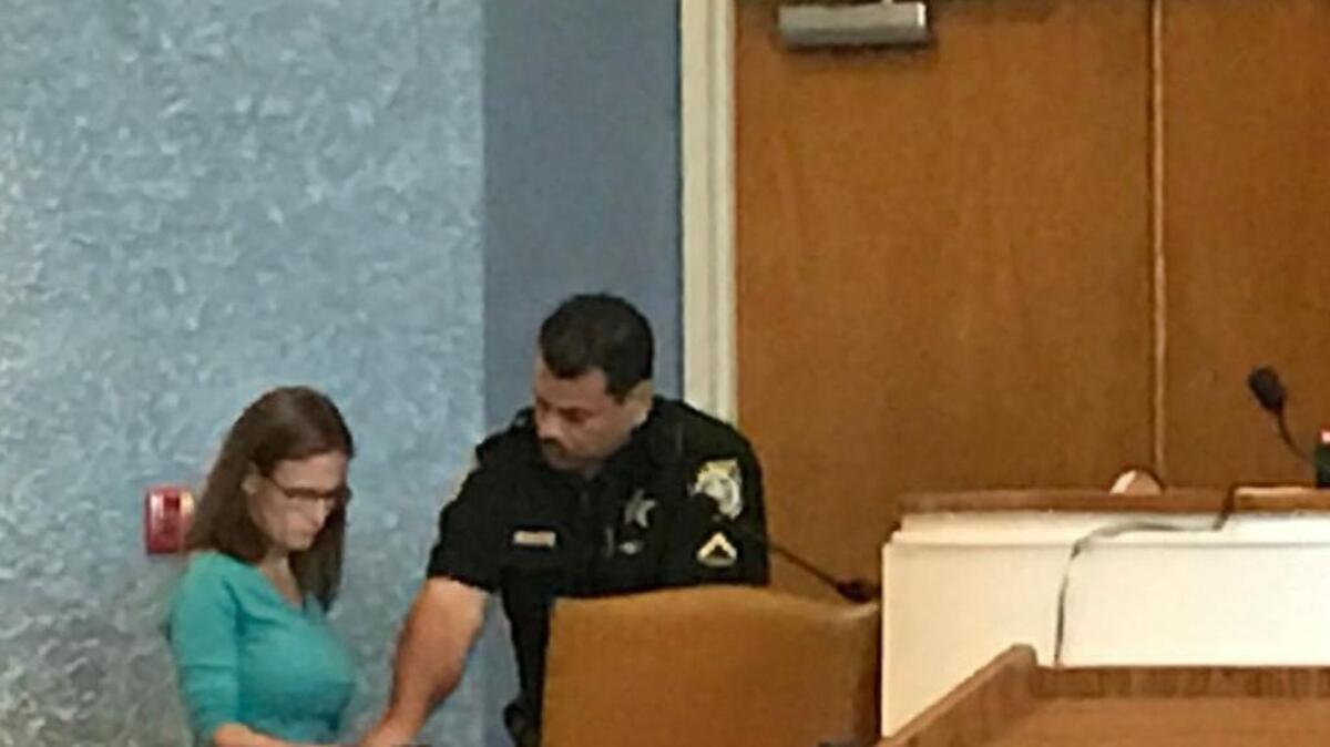 A Monroe County Sheriff’s Office deputy fingerprints Jamie Lynn Anderson, Tuesday, March 6, at the Plantation Key courthouse, after she was sentenced to three years for grand theft of more than $100,000. She pleaded guilty to stealing close to $1 million from Ocean Reef Club while employed there from 2008 to 2014.