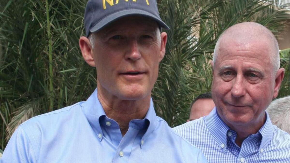 Gov. Rick Scott and Key West hotel owner Robert Spottswood speak to reporters Wednesday.