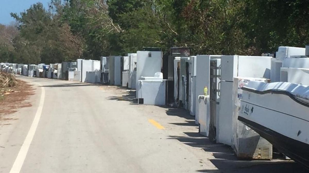 A line of refrigerators, washing machines and other appliances flooded by Hurricane Irma line a section of U.S. 1 on Plantation Key, awaiting collection in recovery from the Category 4 storm.