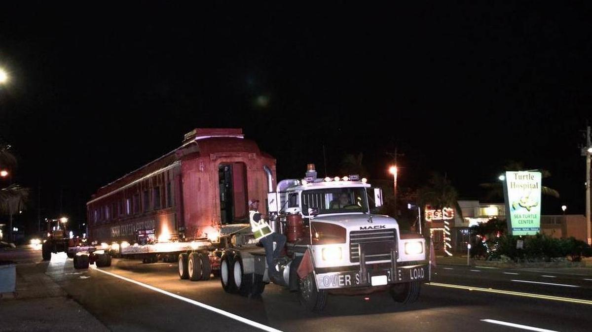A tractor-trailer pulls the the railroad car north on U.S. 1 early Dec. 19 on the way to its new location.
