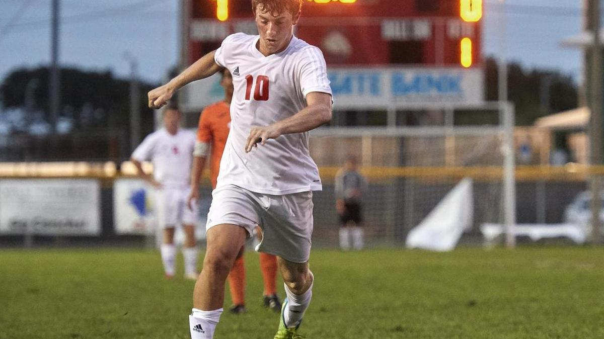 The Tommy Roberts Memorial Stadium scoreboard tells the story as the Conchs’ Noah Cutchin works the ball downfield against Pinecrest Prep on Saturday.