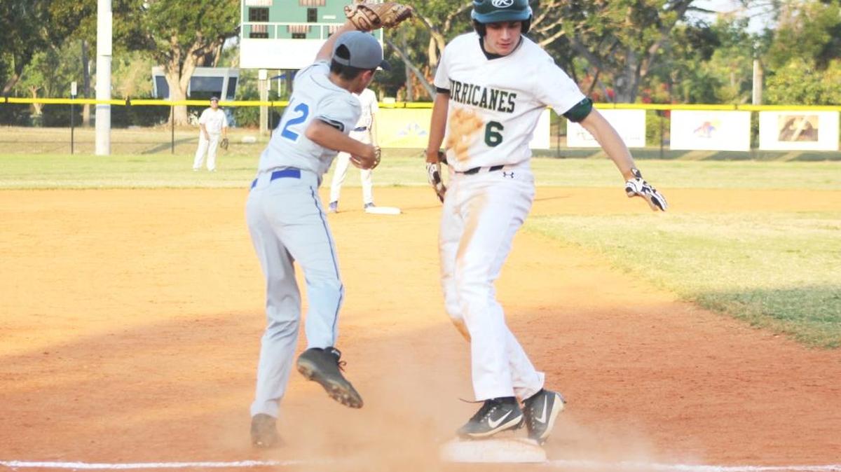 Aiden Hawkins (6) pulls up safely on a slide into third base after his run-scoring triple in the victory over Doctors Charter on Monday.