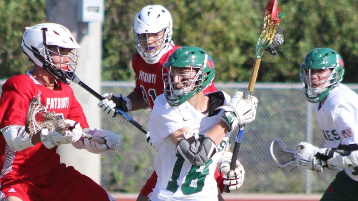 Coral Shores senior Devin Wolf (18) fends off Florida Christian defenders on an attack in the Hurricane win Thursday.