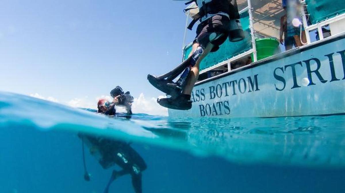 Justin Lansford, 27, a retired staff sergeant from Tampa, takes a giant stride off the boat as he heads out to help plant corals near Looe Key off Big Pine Key. Lansford was a member of the U.S. Army’s 82nd Airborne Division when he lost his leg in a roadside bomb explosion in Afghanistan in 2012.