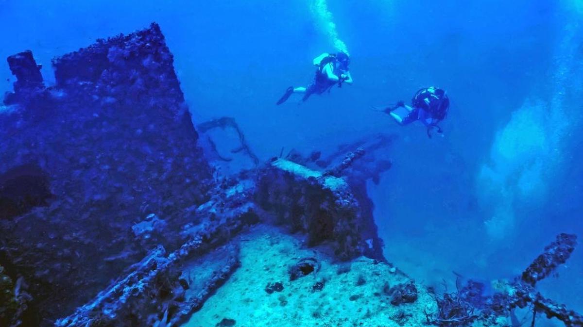 Divers float above the sunken Coast Guard Cutter Bibb.