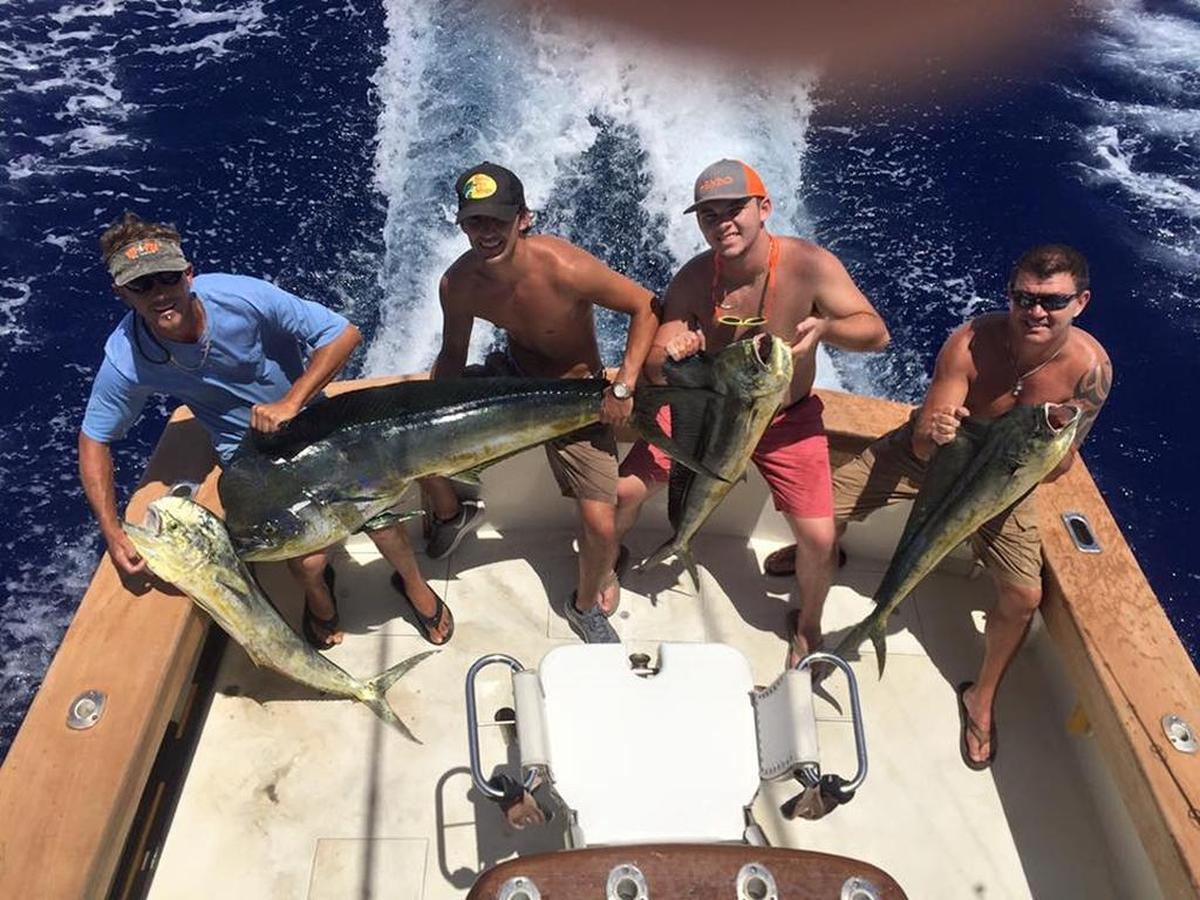 Anglers hold mahi mahi they caught on a 2016 outing with First Choice Charters out of the Post Card Inn Marina at Holiday Isle.