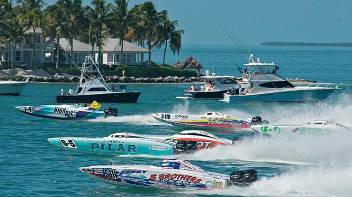 Superboat Stock-class boats cross the start line during the second day of racing at a previous Key West World Championship.